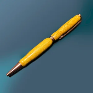 Osage orange handmade pen is made from osage orange wood with gold-colored hardware. The pen is a light orange color with wooden texture.