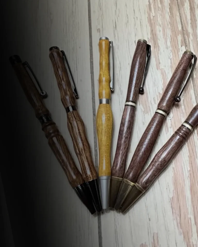 A set of six handmade pens made from different types of high quality wood